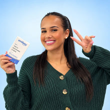 Model holding Smileey PAP+ teeth whitening strips box on a light blue background